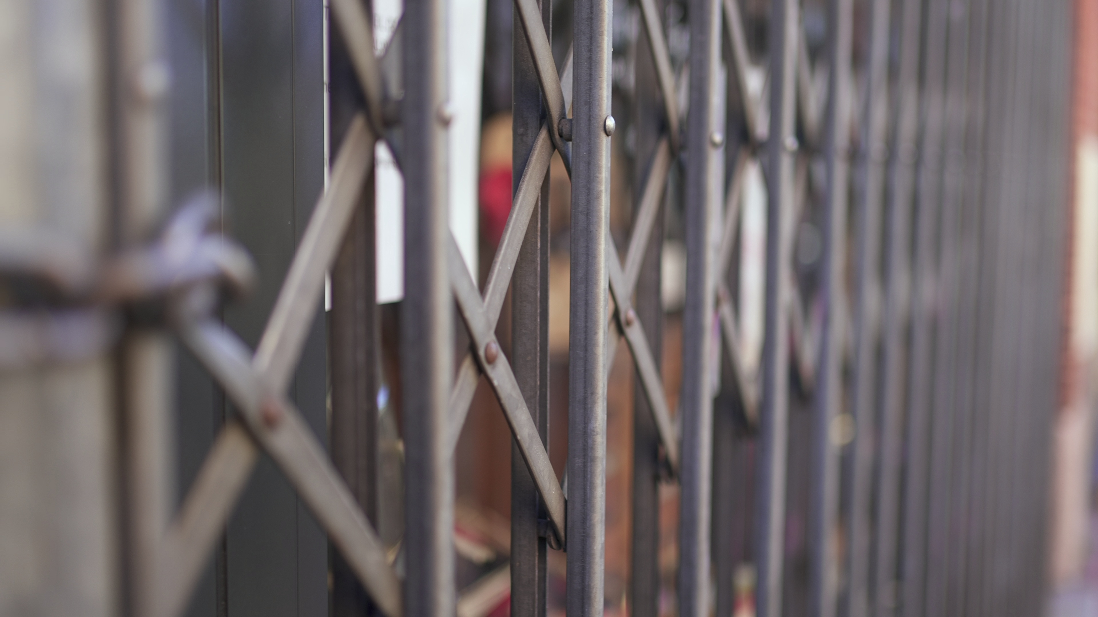 A closed metal shopfront gate.